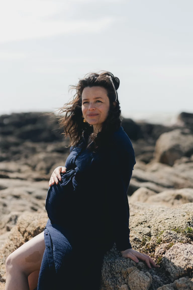 Une jeune femme assise à la plage