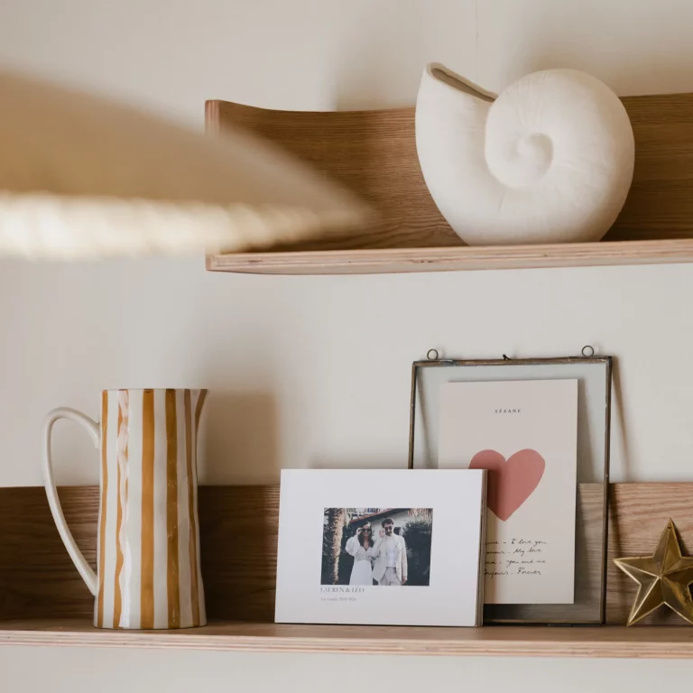 Un livre au page souple tel un album photo est posé sur une étagère dans une maison.